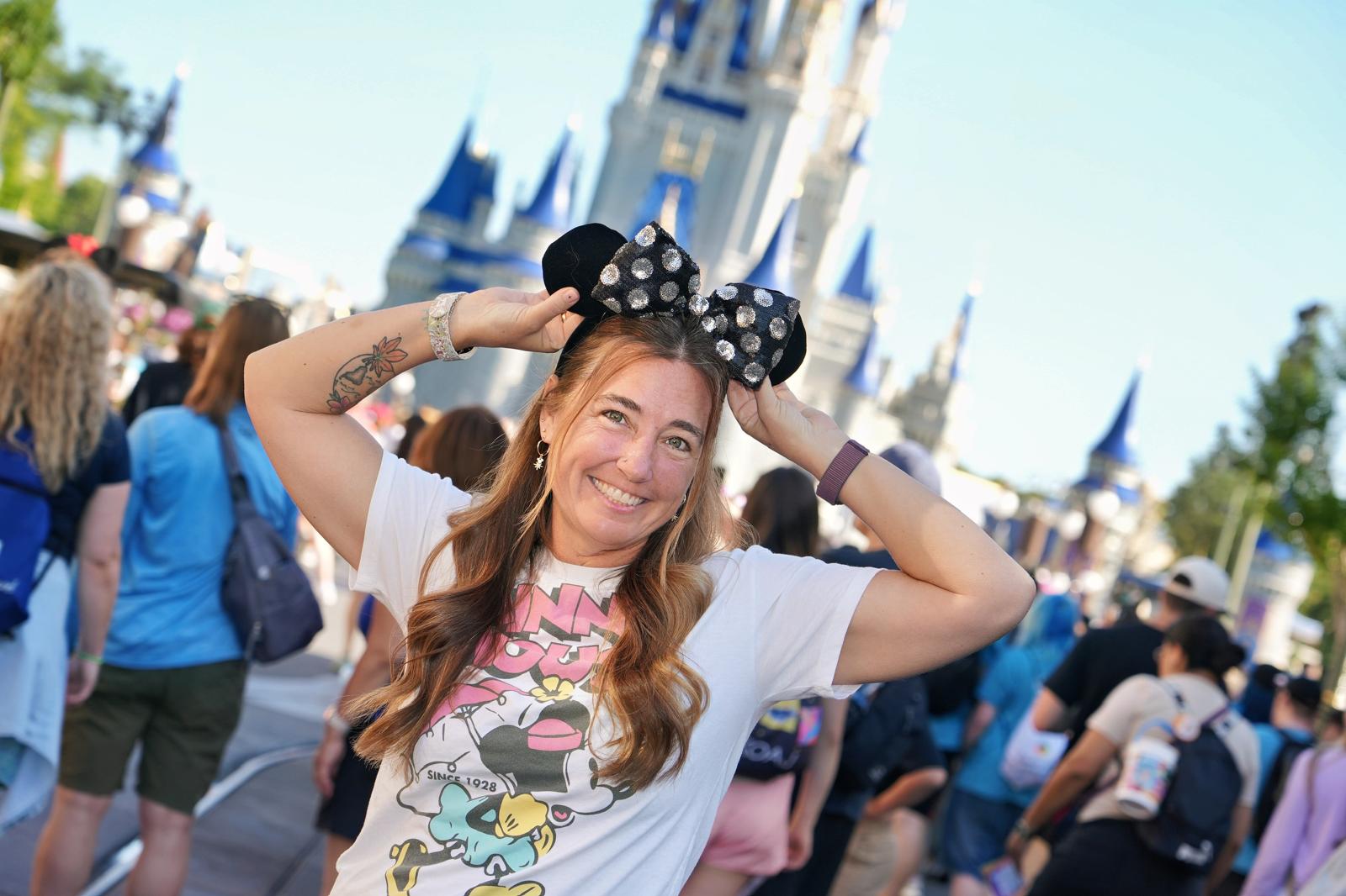 Erin in Minnie ears in front of Cinderella Castle at Walt Disney World